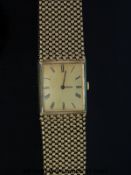 A Swiss 9ct gold gentleman's wristwatch with black hands and Roman numerals, on 9ct gold bracelet,