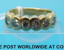 A white metal ring marked 14k set with six diamonds each measuring approximately 0.15ct.