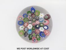 Clichy millefiori star glass paperweight with central pink and green rose,