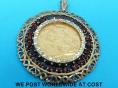 A 1926 gold full sovereign in 9ct gold mount set with garnets (15.