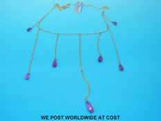 An 18ct gold necklace with seven drop rubies in briolette cut by Philippa Holland