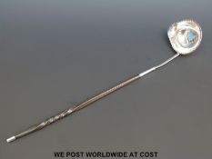 A Georgian white metal whalebone handled toddy ladle, engraved AR to lower handle,