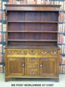 A Georgian oak dresser with plate rack above,