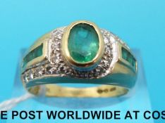 An 18ct gold ring set with emeralds and diamonds (size O)