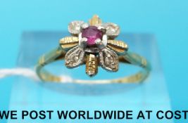 An 18ct gold ring set with a ruby and four diamonds (size N)