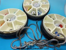 A collection of glass beads with silver centre in a Troll bead case, some full silver beads,