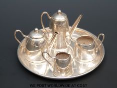 A hallmarked silver doll's house four piece tea set on tray,