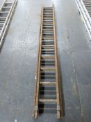 A set of vintage wooden ladders.