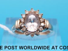 A 9ct rose gold ring set with morganite surrounded by diamonds (size J)