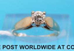 A yellow metal ring marked 14ct set with a round brilliant cut diamond (size I)