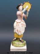 An early 19thC Staffordshire figure of a tambourine player (27cm tall)