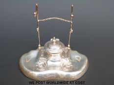 A George V hallmarked silver desk stand with inkwell to base and pen rack above,