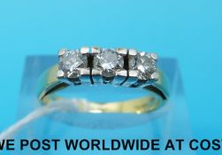 An 18ct gold ring set with three diamonds total diamond weight approximately 0.