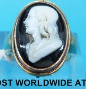 A yellow metal ring set with a cameo.