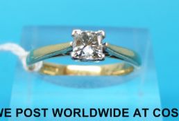 An 18ct gold ring set with a princess cut diamond of approximately 0.