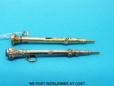 A yellow metal propelling pencil set with turquoise and a gilt example