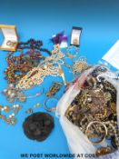 A large collection of costume jewellery to include brooches, necklaces, beads, earrings,