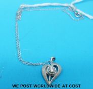 A 14ct white gold necklace and heart pendant set with a round brilliant cut diamond