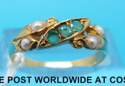A yellow metal ring set with emeralds and seed pearls (size N)