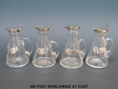 A set of four Hukin & Heath Ltd George V hallmarked silver whiskey noggins with cut glass conical