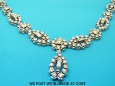 An 18ct white gold necklace set with round brilliant cut and baguette cut diamonds in circular and