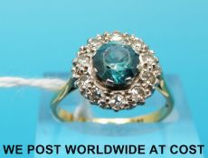 An 18ct gold ring set with a zircon to the centre surrounded by diamonds in a platinum setting