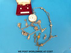 A silver charm bracelet, silver fob watch, pearl earrings,