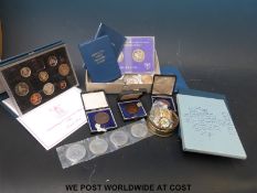 Coin sets including two UK deluxe proof collections,