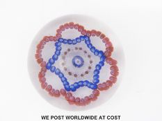Baccarat Dupont patterned millefiori glass paperweight with central blue and white canes surrounded
