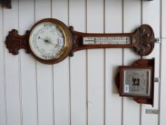 A c1910 oak cased banjo barometer together with a small dial wall barometer