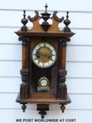 A German Vienna regulator style wall clock with ivory coloured chapter ring, Roman numerals,