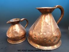 Two Victorian copper measuring jugs, one two gallons, the other half a gallon,