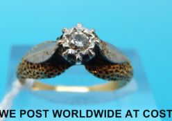 A yellow metal ring marked 15ct set with a diamond in an illusion setting (size N)