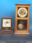 A striking shelf clock in light oak case, 42cm tall, with ivory coloured chapter ring,