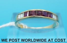 A yellow metal ring marked 585 set with five rubies and six baguette cut diamonds (size O)