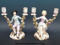 A pair of Meissen male and female figural candlesticks (20.