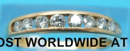 A yellow metal half eternity ring marked 850 set with nine diamonds (size K)