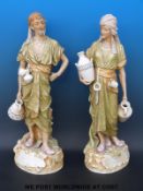 A pair of Royal Dux large size Eastern water carriers decorated in shot silk colours,