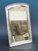 A hallmarked silver framed bevelled edge dressing table mirror with easel back, overall size 33.