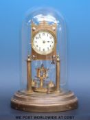 A 400 day Anniversary clock under glass dome sitting on brass base,