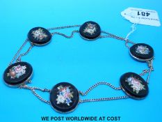 A continental yellow metal micro mosaic necklace made up of six onyx oval sections with flower