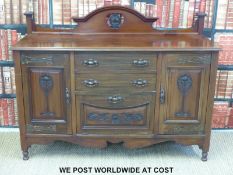 An Art Nouveau mahogany sideboard with stylised metal fittings (width 153cm, depth 54cm,