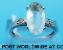 A 9ct white gold ring set with an oval aquamarine and two diamonds (size S)