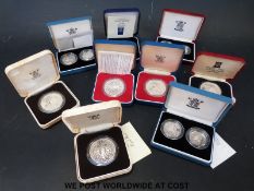 Nine various silver cased coins including small sets, crowns etc.
