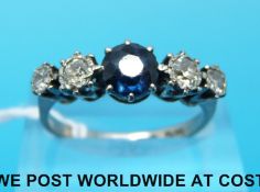 An 18ct white gold ring set with a sapphire and four diamonds in a platinum setting (size Q)
