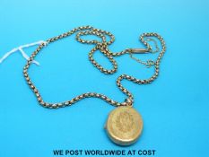 A Victorian locket on a yellow metal chain