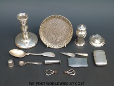 A hallmarked silver candlestick, height 10cm together with a silver pepper, Victorian silver vesta,