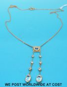 A 9ct gold necklace set with aquamarines in two drop sections, 23cm long.
