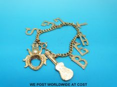 A 1960's gold plated bracelet with charms spelling the word 'Beatles'