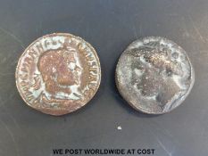 Two ancient bronze coins approximately 30mm diameter.